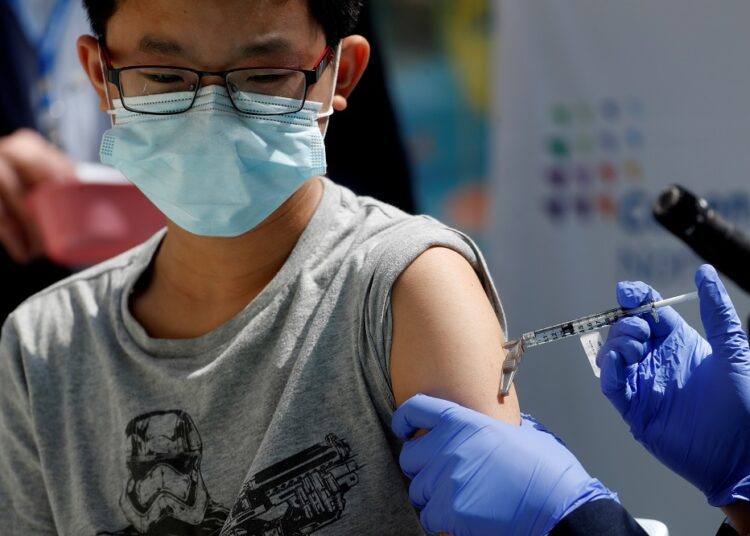 UK minister: No decision yet on Covid-19 vaccines for healthy children 1 - Egyptian Gazette Brendan Lo (13) receiving a dose of the Pfizer-BioNTech vaccine at Northwell Health's Cohen Children's Medical Center in New Hyde Park, New York May 13, 2021.