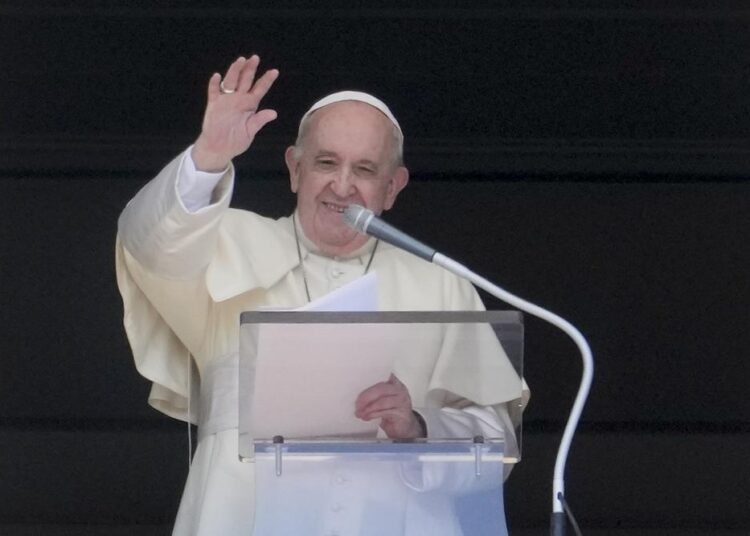 Pope Francis delivers his blessing as he recites the Angelus noon prayer from the window of his studio overlooking St.Peter's Square, at the Vatican, yesterday.