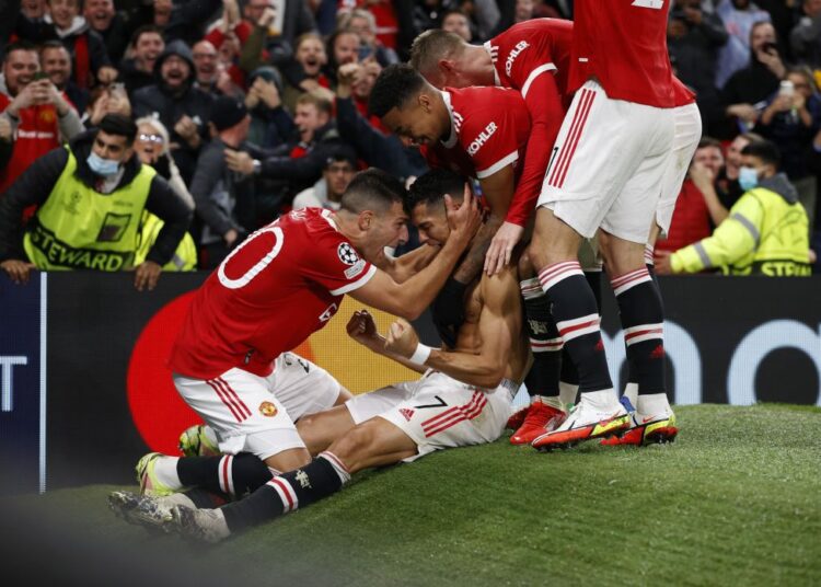 Manchester United's Cristiano Ronaldo celebrates after scoring against Villarreal with teammates at Old Trafford, Manchester.