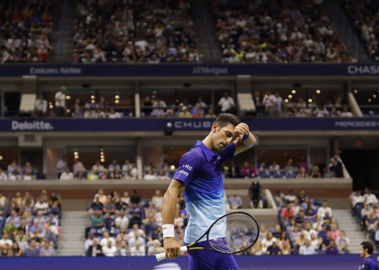 Novak Djokovic of Serbia wipes his face between points against Holger Rune of Denmark at the USTA Billie King National Tennis Centre, New York.