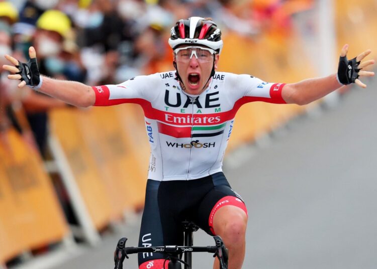 UAE Team Emirates' Tadej Pogacar of Slovenia celebrates as he crosses the finish line of the 115th edition of the Giro di Lombardia.