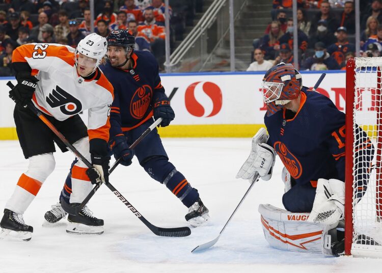 Philadelphia Flyers Oskar Lindblom (L) looks for a pass in front of Edmonton Oilers goaltender Mikko Koskinen (R) during their NHL match.