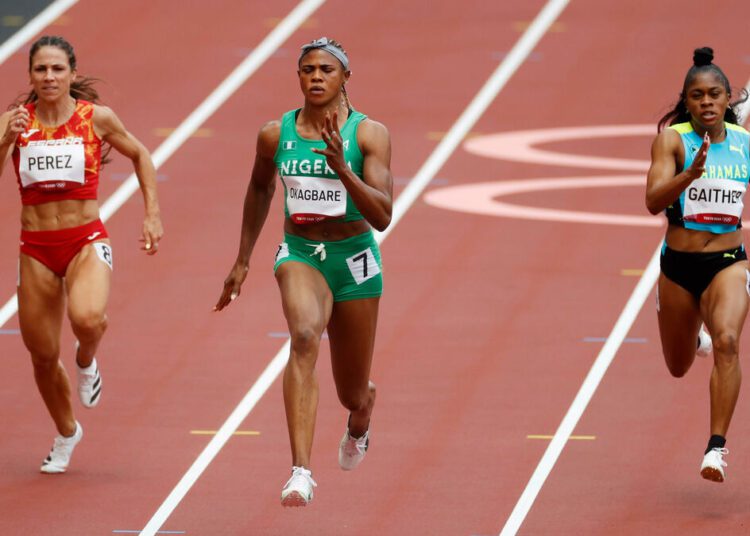Blessing Okagbare, of Nigeria (C) wins a heat in the women s 100-meter run at the Summer Olympics, on July 30, 2021, in Tokyo.