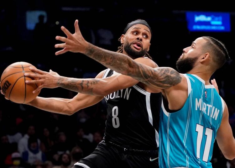 Brooklyn Nets Patty Mills (L) looks to pass against Charlotte Hornets Cody Martin during their NBA game in New York.