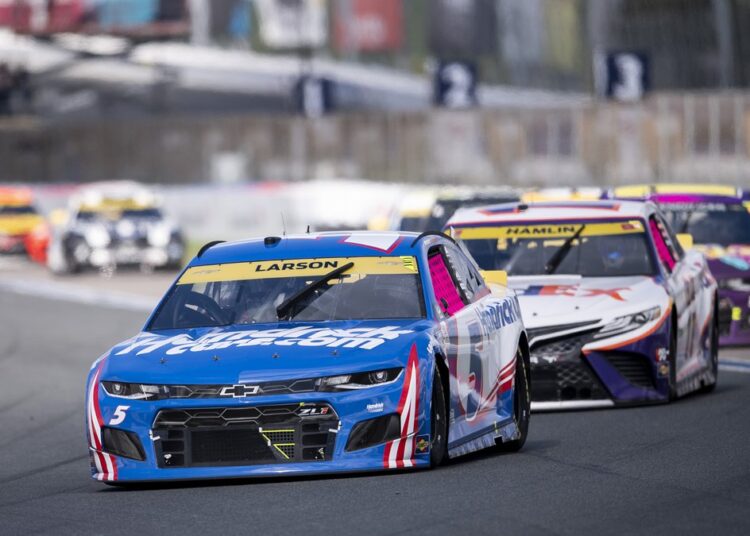 Kyle Larson (5) leads a pack of cars during a NASCAR Cup Series auto racing race at Charlotte Motor Speedway, in Concord.