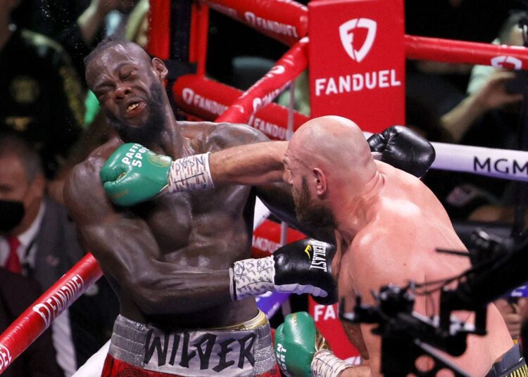 Wilder to undergo surgery after Fury loss 1 - Egyptian Gazette Tyson Fury (R) lands a right hand on Deontay Wilder at the eighth round of the WBC heavyweight title match.