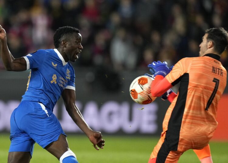 Sparta's goalkeeper Florin Nita (R) saves the ball ahead of Rangers' Fashion Sakala during the Europa League Group A match in Prague, Czech Republic.