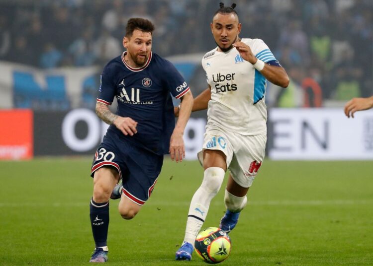 Paris St Germain's Lionel Messi (L) in action with Marseille's Dimitri Payet at the Orange Velodrome, Marseille.