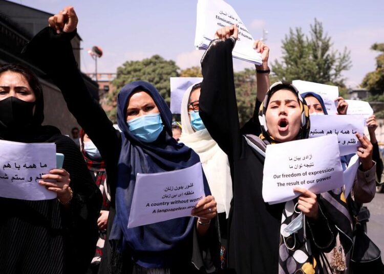 A file photo showing Afghan women's rights defenders and civil activists protest to call on the Taliban for the preservation of their achievements and education, in front of the presidential palace in Kabul, Afghanistan.