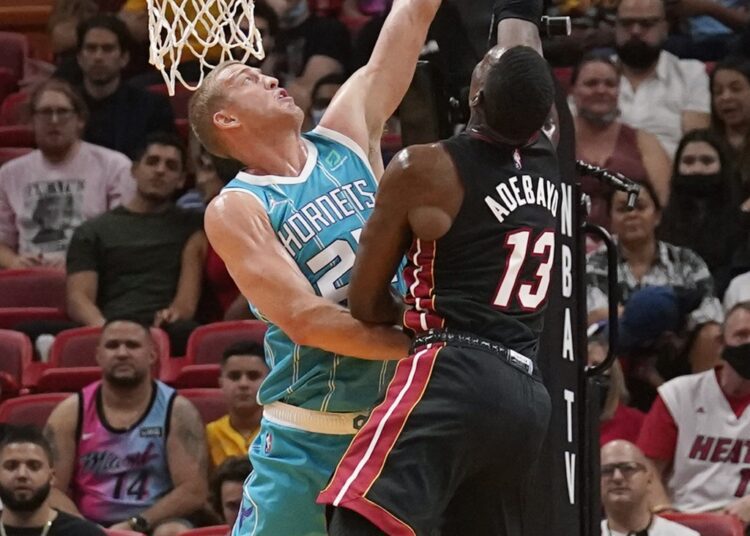 Charlotte Hornets Mason Plumlee (L) blocks a shot to the basket by Miami Heat Bam Adebayo during their NBA game in Miami.