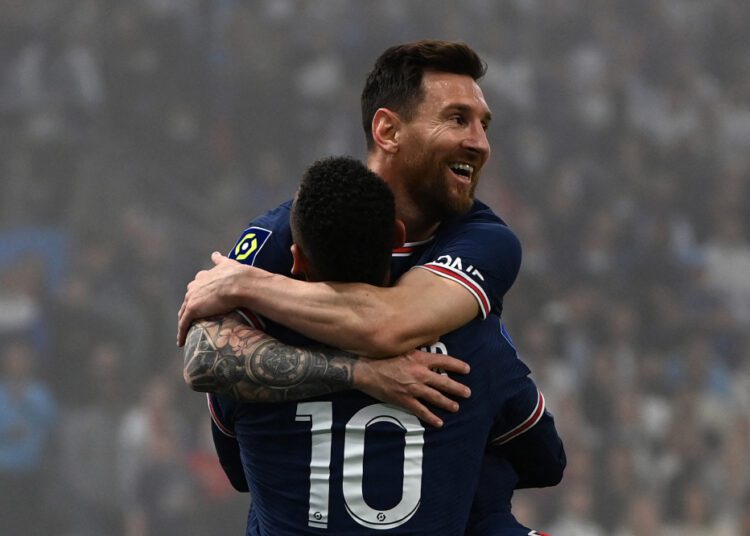 Paris Saint-Germain's Argentinian forward Lionel Messi (up) and Paris Saint-Germain's Brazilian forward Neymar celebrate a goal that was later invalidated by the video assistant referee (VAR) during the French L1 football match between Olympique Marseille (OM) and Paris Saint-Germain's (PSG) at Stade Velodrome in Marseille, southern France, on October 24, 2021. (Photo by CHRISTOPHE SIMON / AFP)