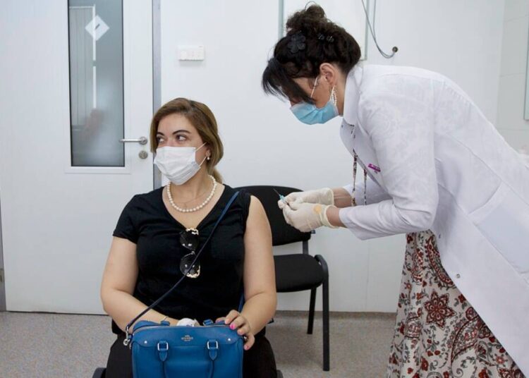 A woman gets a shot of the Pfizer Covid-19 vaccine in Georgia.