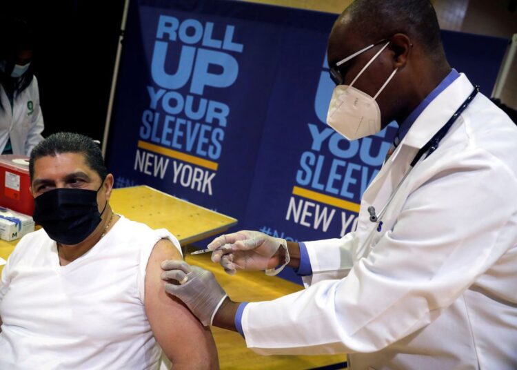 US administers nearly 412 mln doses of COVID-19 vaccines 1 - Egyptian Gazette Eugenio Brito, vice president of Bodegas of America, receives a Pfizer vaccination shot amid the coronavirus disease (COVID-19) pandemic, in the Harlem section of Manhattan in New York City, New York, US, April 23, 2021.