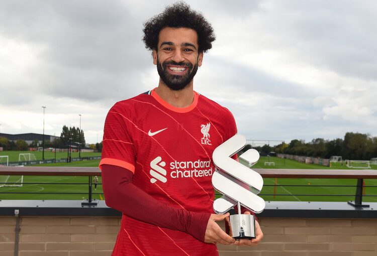 Mohamed Salah posing with the Standard Chartered Men's Player of the Month award for September.