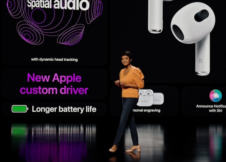 Apple’s Susmita Dutta showcases the third-generation AirPods featuring spatial audio during a special event at Apple Park in Cupertino, California in a photograph released October 18, 2021.