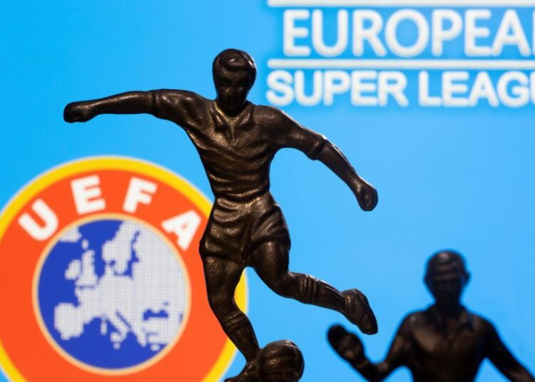 Metal figures of football players are seen in front of the words ‘European Super League’ and the Uefa logo in this illustration taken.