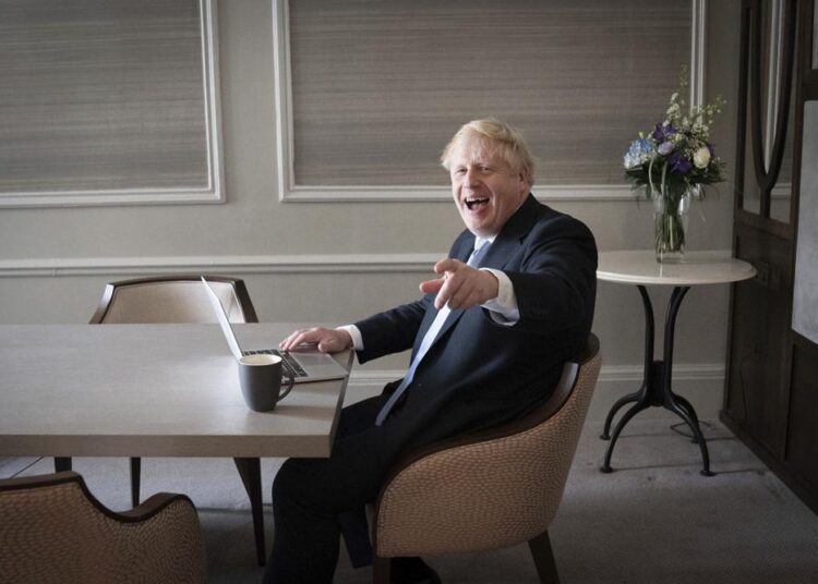Boris Johnson hailed by his party despite UK’s economic woes 1 - Egyptian Gazette FILE - In this Oct. 5, 2021, file photo, Britain's Prime Minister Boris Johnson prepares his keynote speech in his hotel room in Manchester, England, before addressing the Conservative Party Conference. Johnson ends the four-day conference on Wednesday, Oct. 6, with a speech promising that Britain will emerge from Brexit and the coronavirus pandemic as a stronger, more dynamic country — even if the road is slightly rocky.