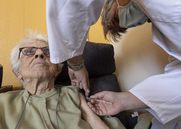 A woman gets a COVID-19 Pfizer booster shot in the "Im Lauesch" nursing home of Strasbourg, eastern France.
