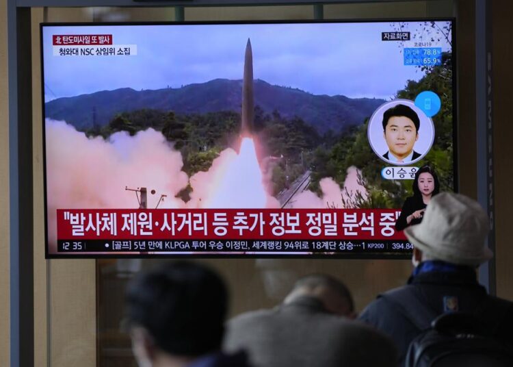 People watching a TV screen showing a news programme reporting about North Korea's missile launch with file footage at a train station in Seoul, South Korea, Tuesday, Oct. 19, 2021.