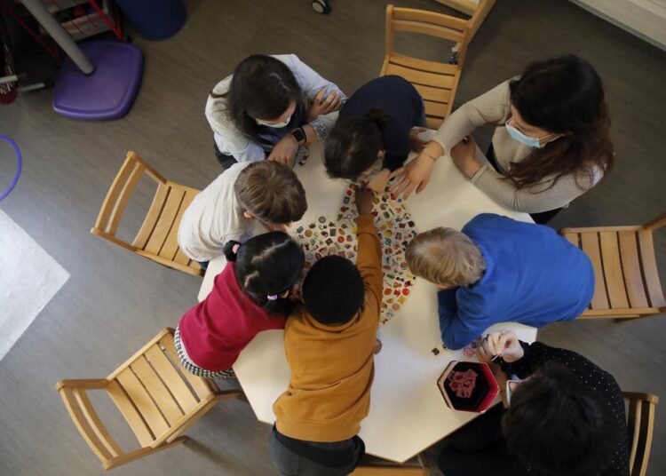 UNICEF: Battered by Covid, kids need mental health help 1 - Egyptian Gazette A file photo of children playing with a therapist in the pediatric unit of the Robert Debre hospital, in Paris.