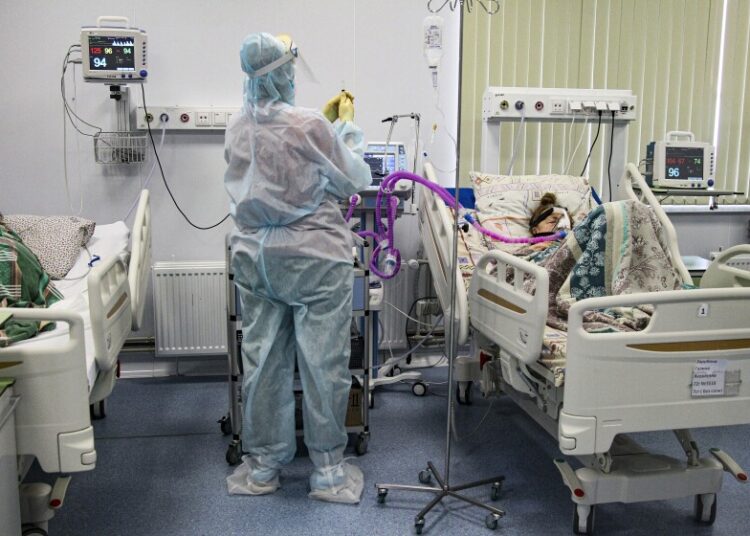 Russia's infections, deaths soar to another record 1 - Egyptian Gazette A medical worker wearing a special suit to protect against COVID-19 treats a patient at an ICU in Infectious Hospital No. 23 in Nizhny Novgorod, Russia, on Oct. 20, 2021.