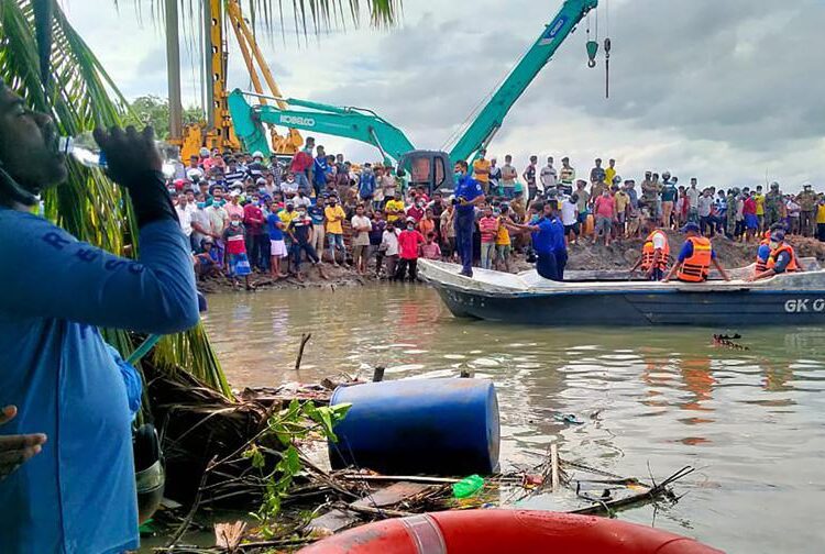 Sri Lankan police and navy life savers attend the rescue work following a ferry capsized in Kinniya, about 267 kilometres east of Colombo, Sri Lanka on Tuesday, Nov. 23, 2021. At least six people have died after a ferry capsized in eastern Sri Lanka, Navy official says.