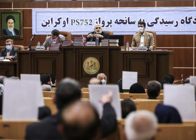 Iran publishes photos of closed hearing into plane shootdown 1 - Egyptian Gazette This photo released by Mizan News Agency, shows a hearing in an Iranian military courtroom for the 2020 downing of a Ukrainian plane that killed 176 people, Sunday, Nov. 21, 2021, in Tehran, Iran. The banner at rear next to the portrait of the late Iranian revolutionary founder Ayatollah Khomeini reads in Persian: "The trial of Ukrainian flight PS752 accident."