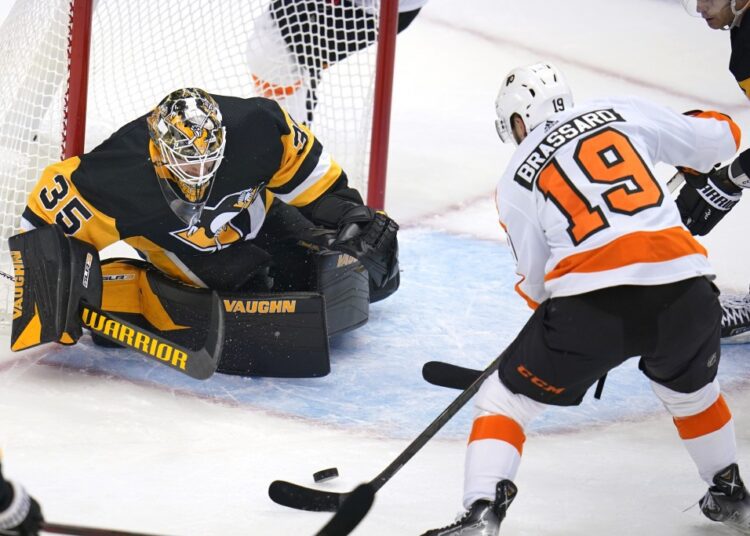 Letang's overtime winner lifts Penguins past Flyers 1 - Egyptian Gazette Pittsburgh Penguins goaltender Tristan Jarry (L) blocks a shot attempt by Philadelphia Flyers' Derick Brassard during their NHL game in Pittsburgh.