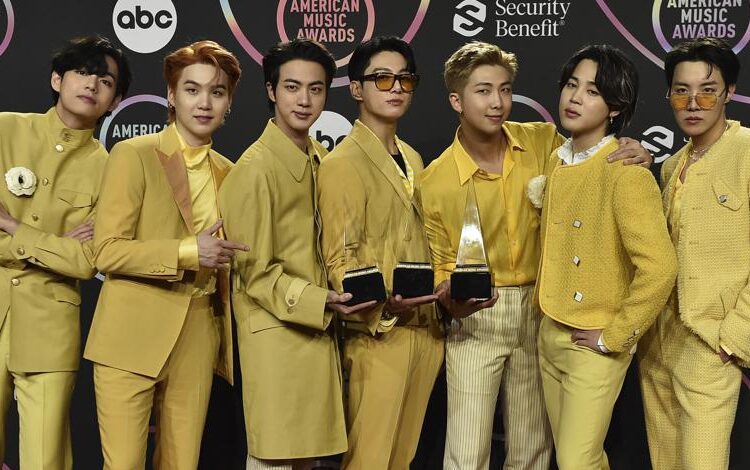 BTS poses in the press room with the awards for favorite pop duo or group, favorite pop song for “Butter,” and artist of the year at the American Music Awards on Sunday, Nov. 21, 2021, at Microsoft Theater in Los Angeles. (Photo by Jordan Strauss/Invision/AP)