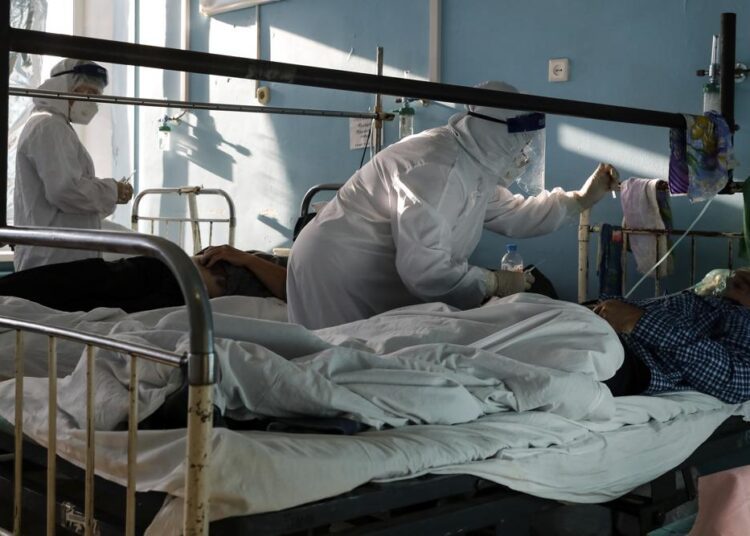 Medics wearing special suits to protect against coronavirus treat patients with coronavirus at an ICU of a hospital in Volgograd, Russia, Sunday, Nov. 21, 2021. The latest surge in deaths comes amid low vaccination rates and lax public attitudes in Russia toward taking precautions. About 40% of Russia's nearly 146 million people have been fully vaccinated, even though the country approved a domestically developed COVID-19 vaccine — Sputnik V — months before most of the world.