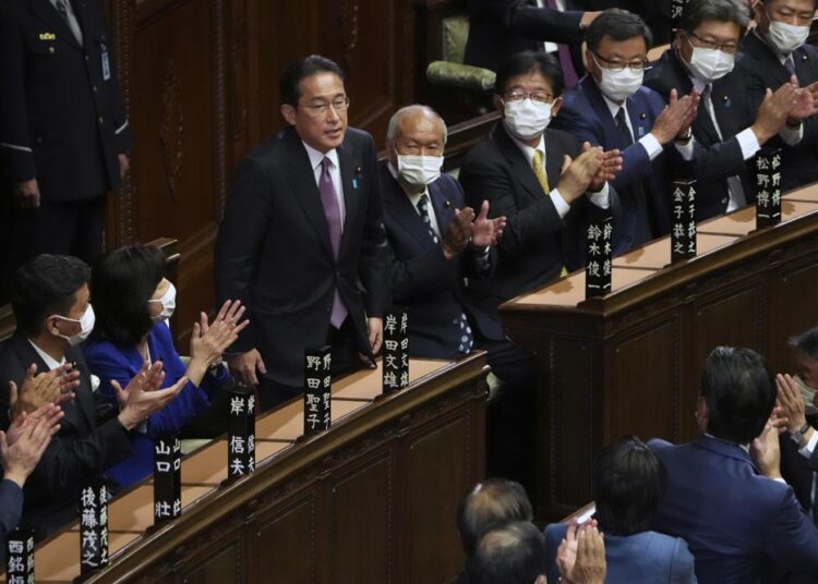 Fumio Kishida, (C), bows after being reelected as Japan's prime minister at the parliament's lower house on Wednesday, November 10, 2021, in Tokyo.