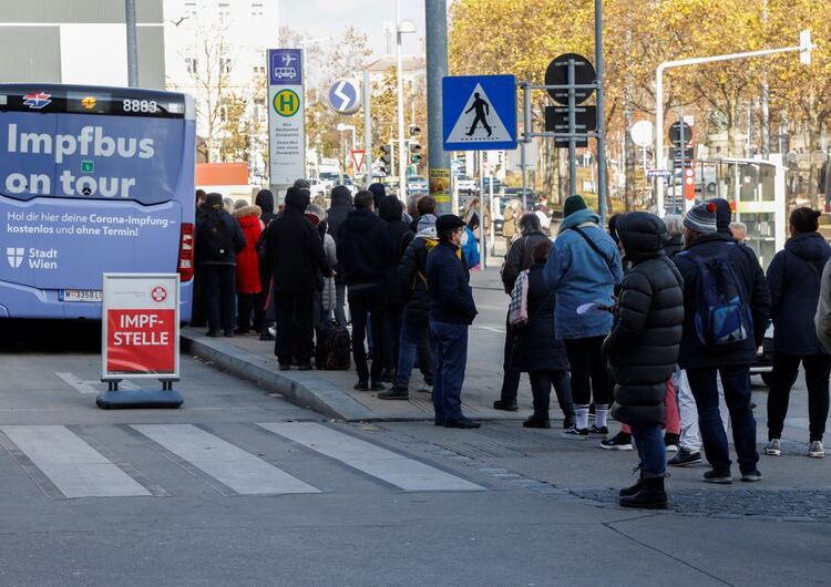 People waiting in front of a vaccination bus during the coronavirus disease outbreak, as Austria's government has imposed a lockdown on people who are not fully vaccinated.