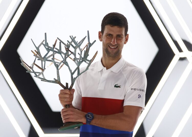 Djokovic focuses on positives after winning Paris Masters 1 - Egyptian Gazette Serbia's Novak Djokovic holds the trophy and celebrates winning the Paris Masters.