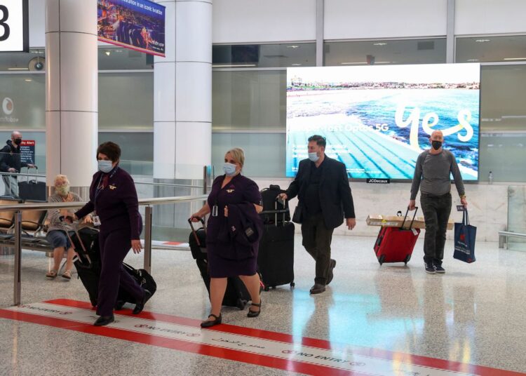 Travellers and flight crew members arriving at the international terminal at Sydney Airport, as countries react to the new coronavirus Omicron variant, in Sydney, Australia, November 30, 2021.