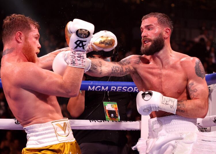 Caleb Plant lands a right to Canelo Alvarez during a super middleweight title unification fight in Las Vegas.