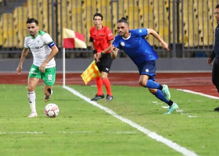 Al-Masry’s left-back player Ahmed Shedeed (L) vying for the ball against Smouha player at Petrosport Stadium in the Egyptian Premier League.