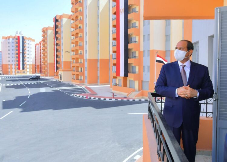 President Abdel Fattah El Sisi looking at blocks of flats during his opening of one of the housing projects to relocate residents of slums into decent accommodations.