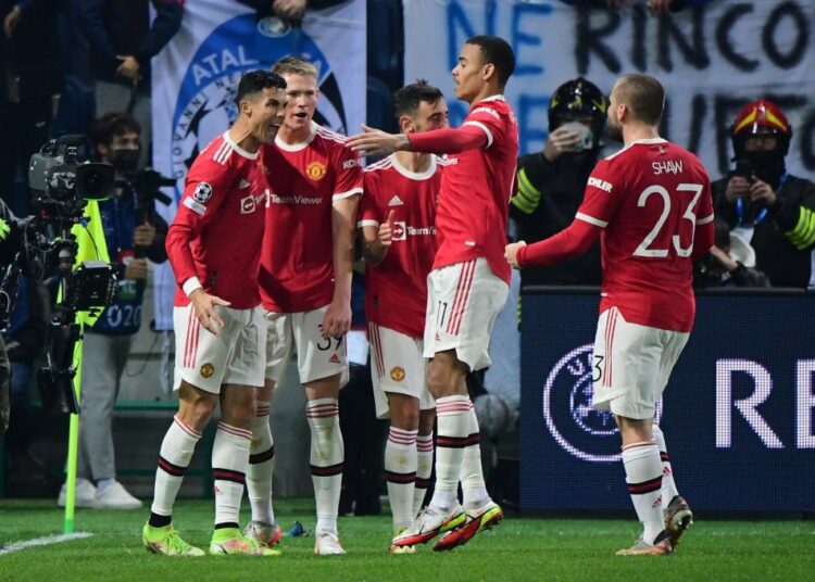 Manchester United's Cristiano Ronaldo celebrates scoring their first goal against Atalanta with teammates at Stadio Atleti Azzurri, Bergamo.