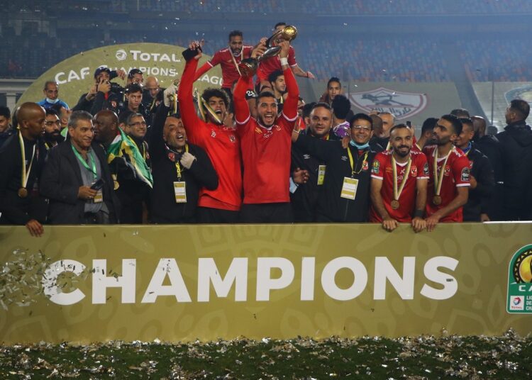 Al-Ahly's players celebrate with the 2020 CAF Champions League trophy.