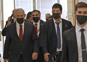 Netanyahu appears in court as ex-aide prepares to take stand