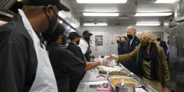Biden, VP and spouses assist food kitchen for holiday