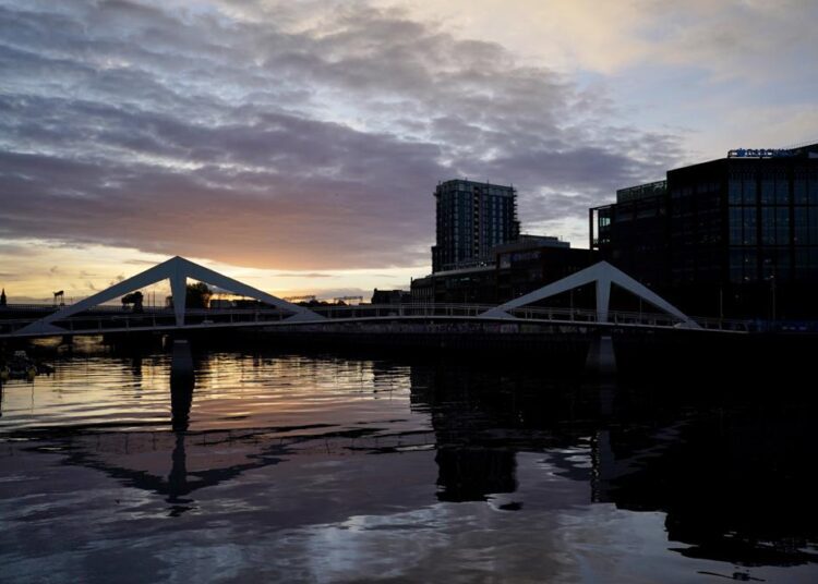 The sun begins to rise over the River Clyde outside the venue of the COP26 U.N. Climate Summit in Glasgow, Scotland, Tuesday, Nov. 2, 2021. The U.N. climate summit in Glasgow gathers leaders from around the world, in Scotland's biggest city, to lay out their vision for addressing the common challenge of global warming.