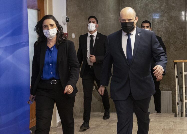 Israeli Prime Minister Naftali Bennett, right, and Israeli Interior Minister Ayelet Shaked, left, arrive for the weekly cabinet meeting in Jerusalem, Sunday, Dec. 12, 2021. Bennett announced that he would make the first official visit by a sitting premier to the United Arab Emirates on Sunday as part of a blitz of regional diplomacy amid the backdrop of struggling nuclear talks with Iran.