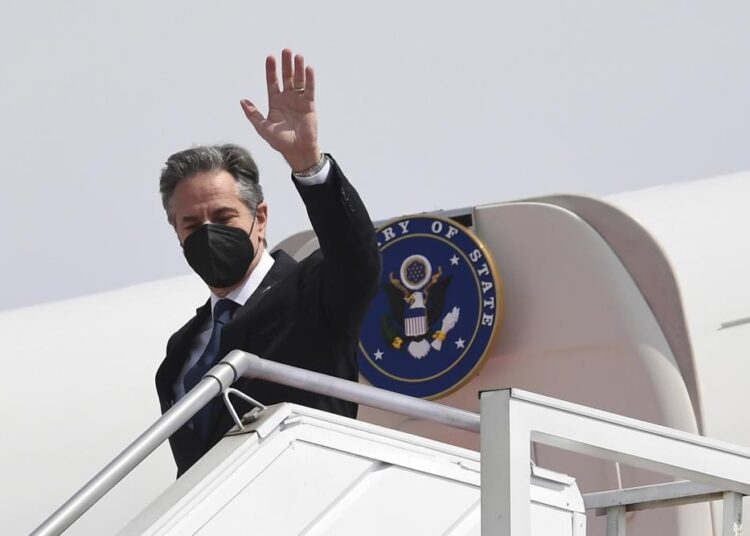 U.S. Secretary of State Antony Blinken waves as he arrives at the international airport in Jakarta on Monday, Dec. 13, 2021. Blinken arrives in Indonesia on his first stop of a three-nation tour across Southeast Asia.
