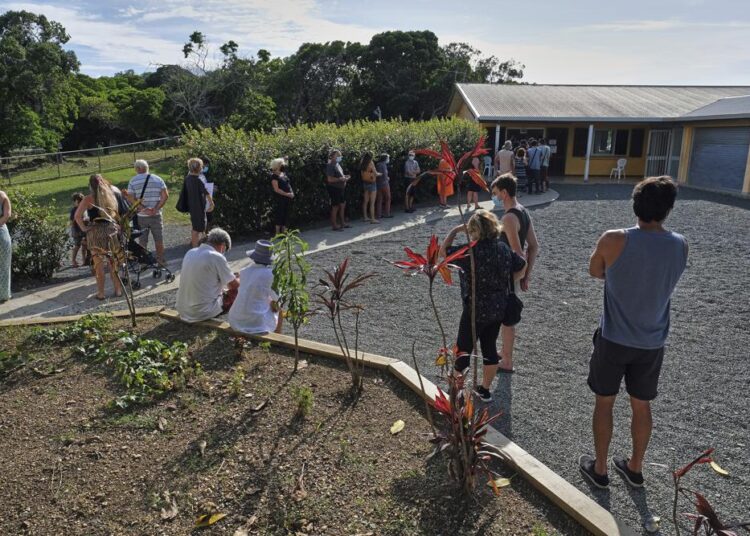 New Caledonia votes on whether to stay part of France 1 - Egyptian Gazette People queue outside a school to vote in a referendum in Noumea, New Caledonia, Sunday Dec.12, 2021. Voters in the South Pacific archipelago of New Caledonia decide whether to break away from France, a referendum that is important for French geopolitical ambitions and is being closely watched amid growing Chinese influence in the region. But pro-independence forces are refusing to take part, accusing the French government of trying to rush through the vote.