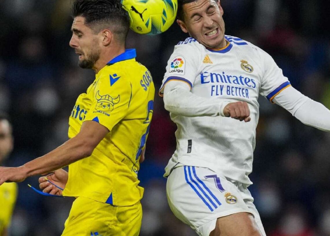Real Madrid's Eden Hazard (R) and Cadiz's Ruben Sobrino head the ball during their La Liga match in Madrid.