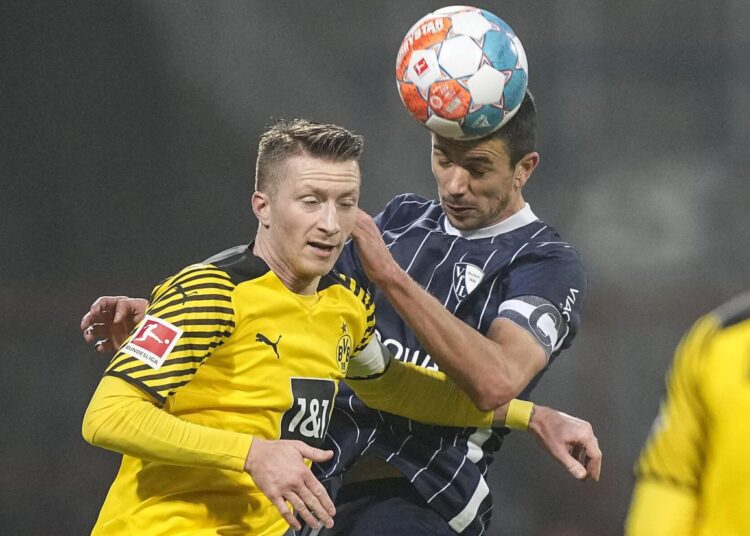 Bayern extends league lead as Dortmund draws at Bochum 1 - Egyptian Gazette Bochum's Anthony Losilla (R) and Dortmund's Marco Reus challenge for the ball during their German Bundesliga match in Bochum.