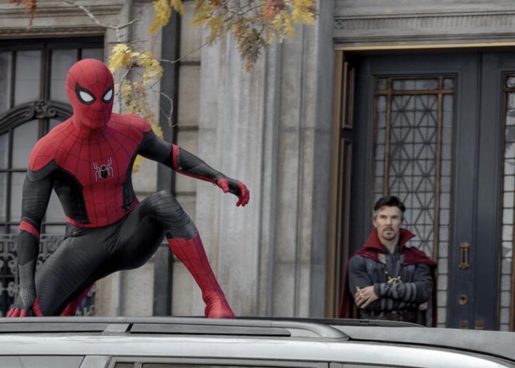 This image released by Sony Pictures shows Tom Holland, left, and Benedict Cumberbatch in Columbia Pictures' "Spider-Man: No Way Home." (Sony Pictures via AP)