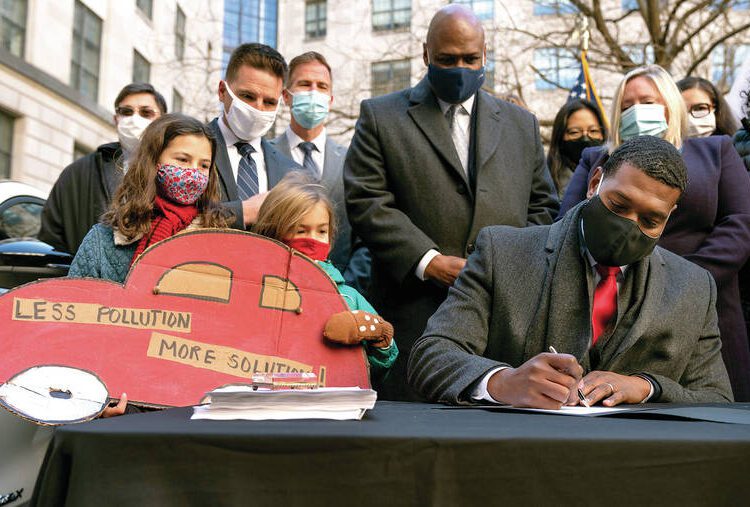 Environmental Protection Agency Administrator Michael Regan ceremonially signs the Agency's final rule for federal greenhouse gas emissions standards for light duty vehicles in Washington.