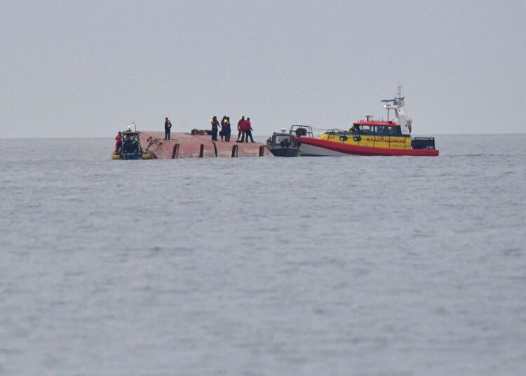 Rescue workers work aboard the Danish cargo ship Karin Hoej which collided with the British cargo ship Scot Carrier between Ystad and Bornholm, on the Baltic Sea December 13, 2021.